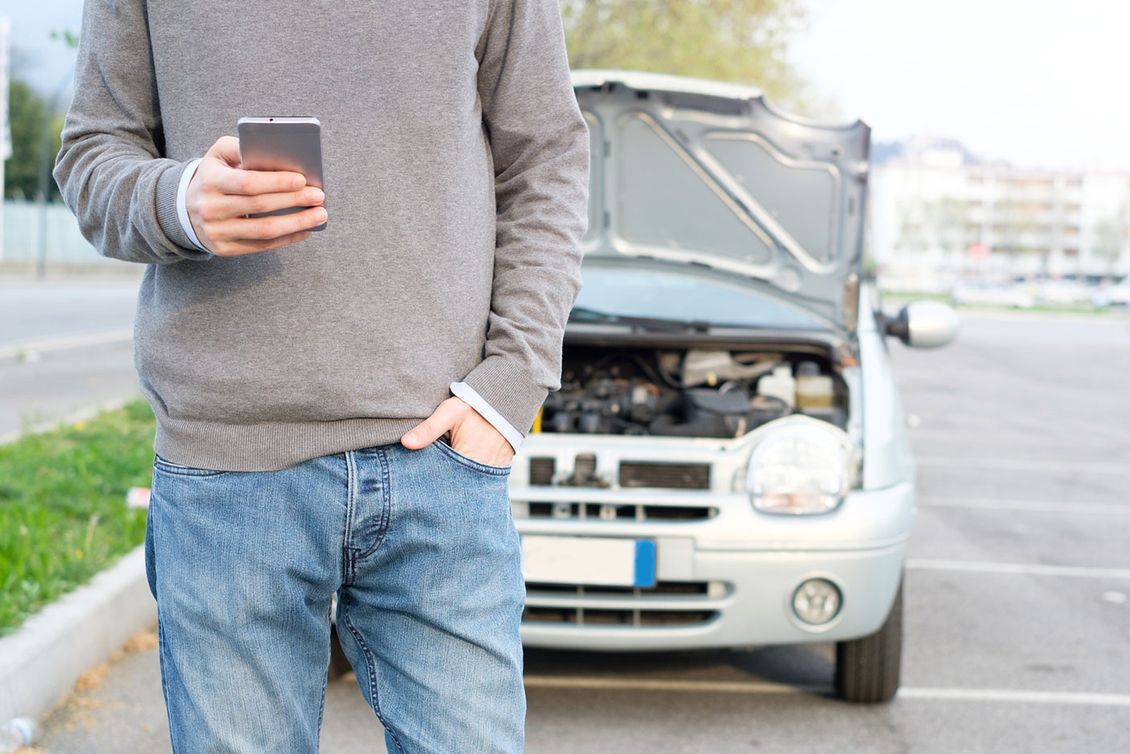 A customer on his phone to a mechanic after breaking down