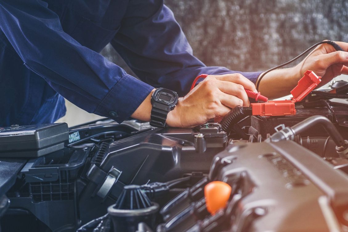 Mechanic making repairs to a car engine