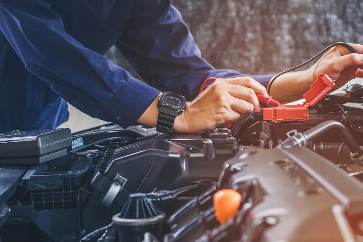 Mechanic making repairs to a car engine