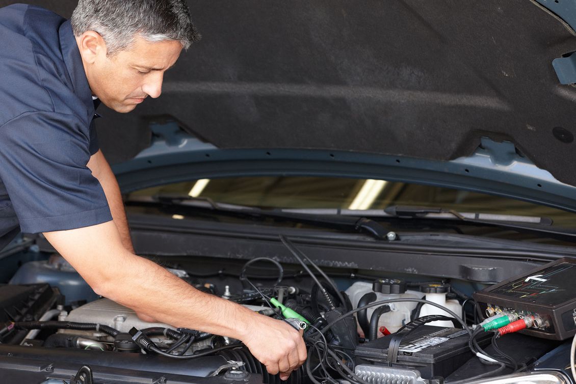 A mechanic making repairs to a car