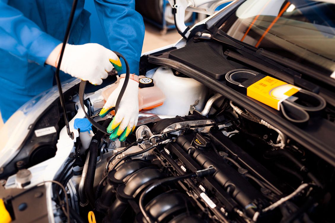A Mechanic installing a new timing belt