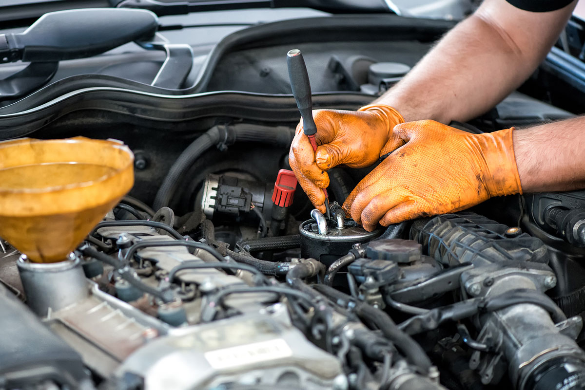 A mechanic making repairs to a customer car